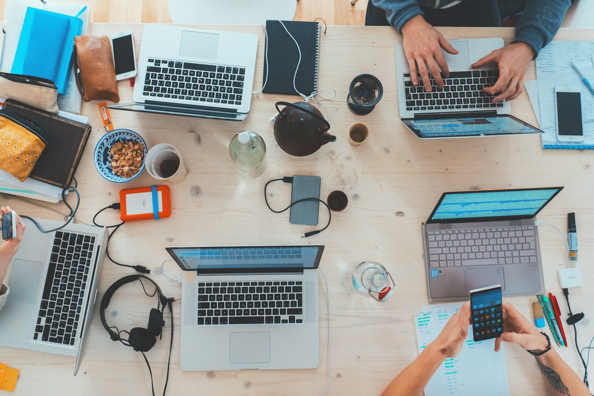 Stock photograph of people exchanging ideas around a table